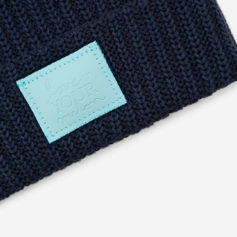 Navy Double Pom Beanie (Light Blue Leather Patch)